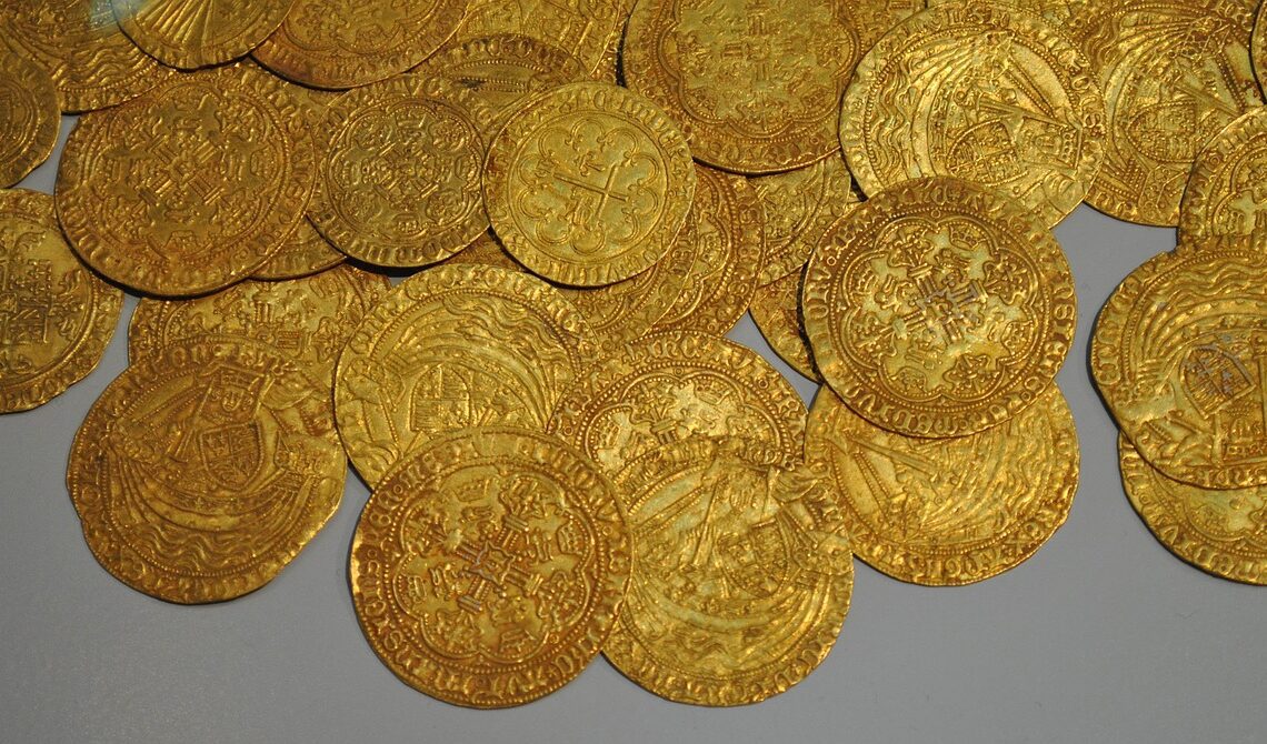 Zimbabwe, gold coins over grey background