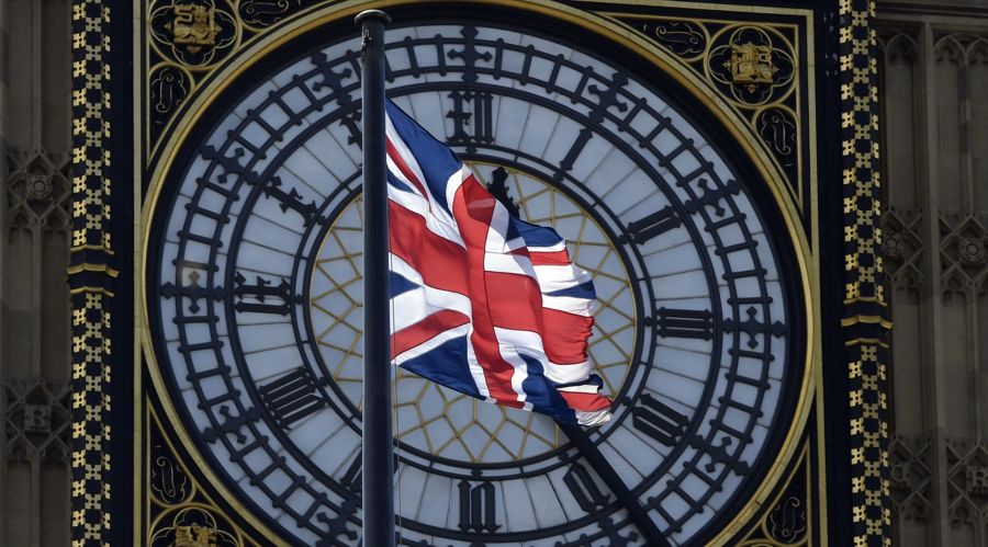 A Union Flag flies in front of the Big Ben clock the Houses of Parliament in central London
